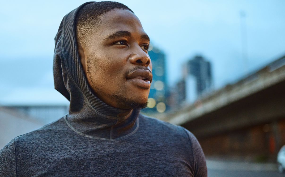 Man gazing thoughtfully in urban setting.