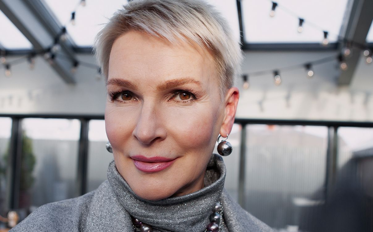 Stylish woman with short hair and earrings.