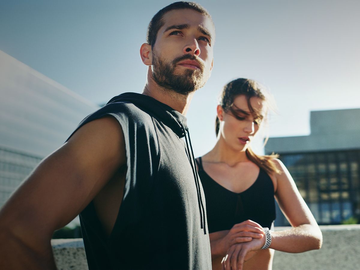 Two athletes preparing for a workout outdoors.